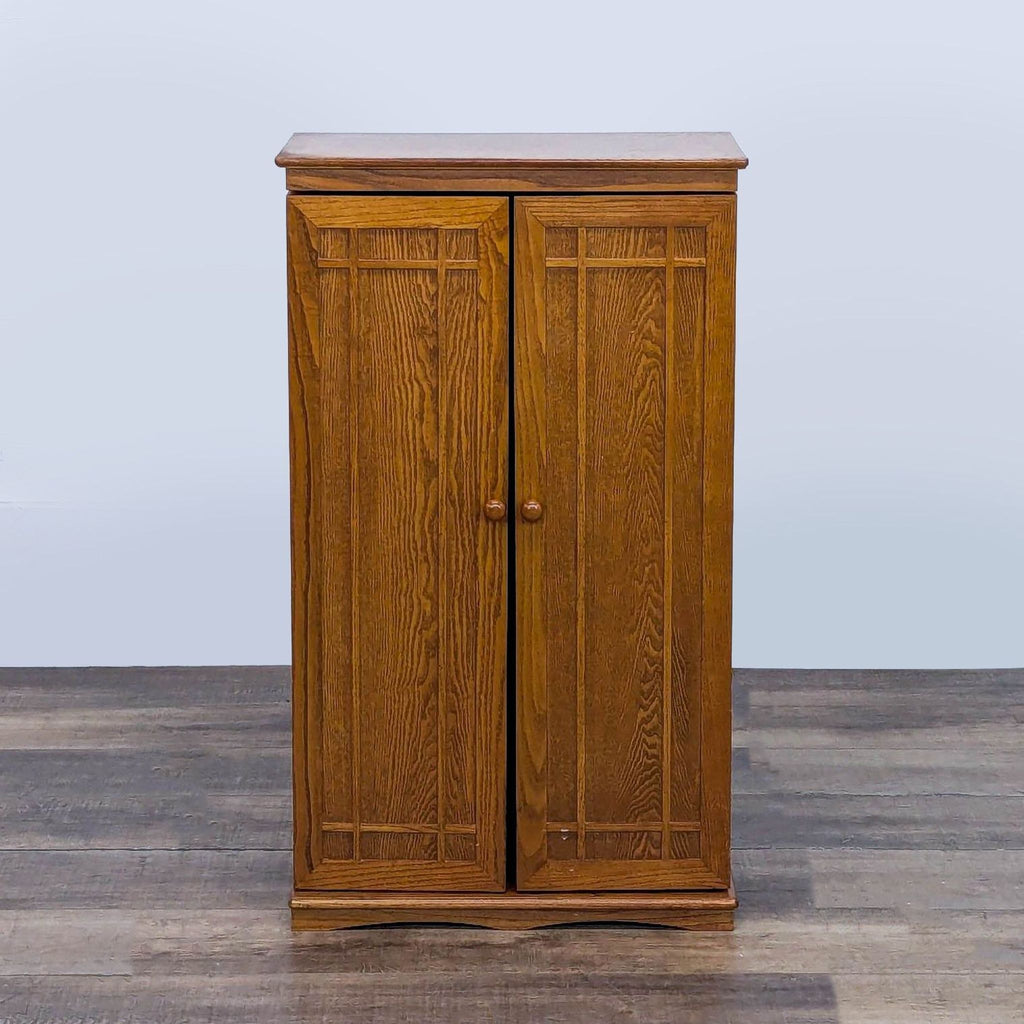 1. Wooden multimedia cabinet with two closed hinged doors. 