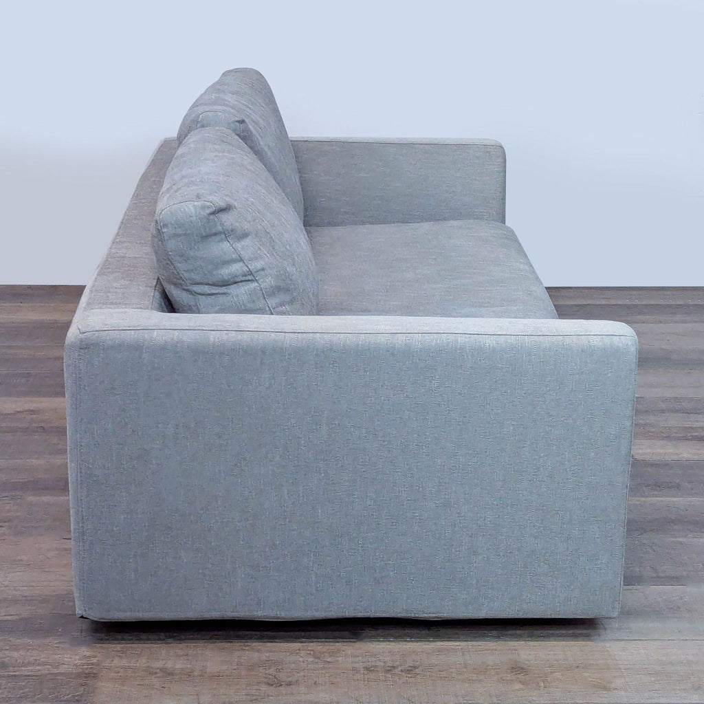 Side view of Relax Form loveseat showing sleek design and cushioned seating.