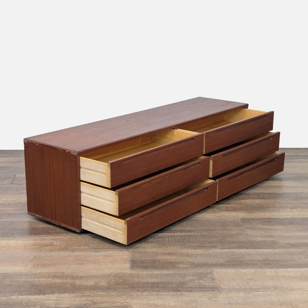 Side view of Reperch dresser, six drawers open, showcasing spacious interior.