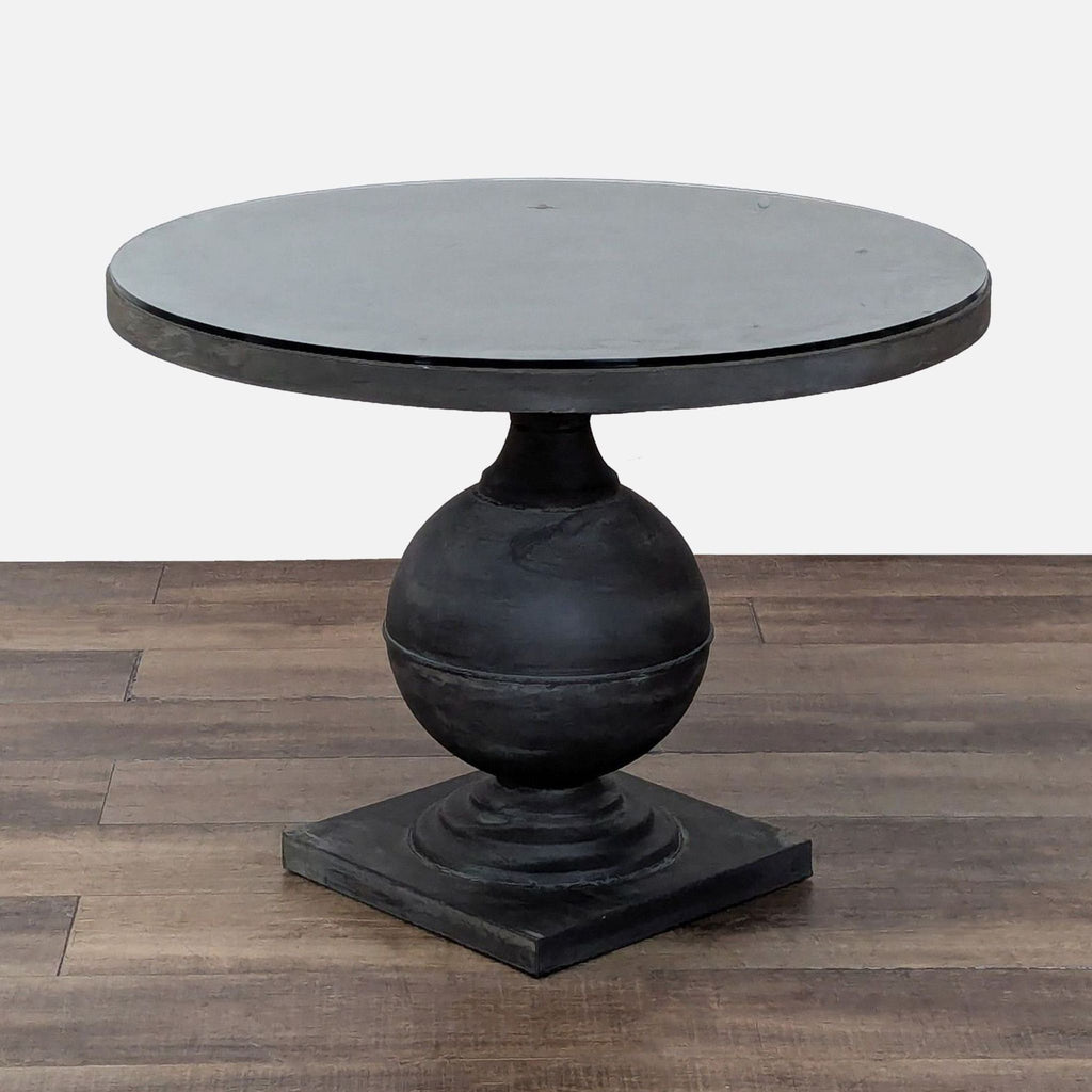 2. Modern Reperch dining table, featuring a circular glass top and bold geometric base, suitable for indoors/outdoors.  