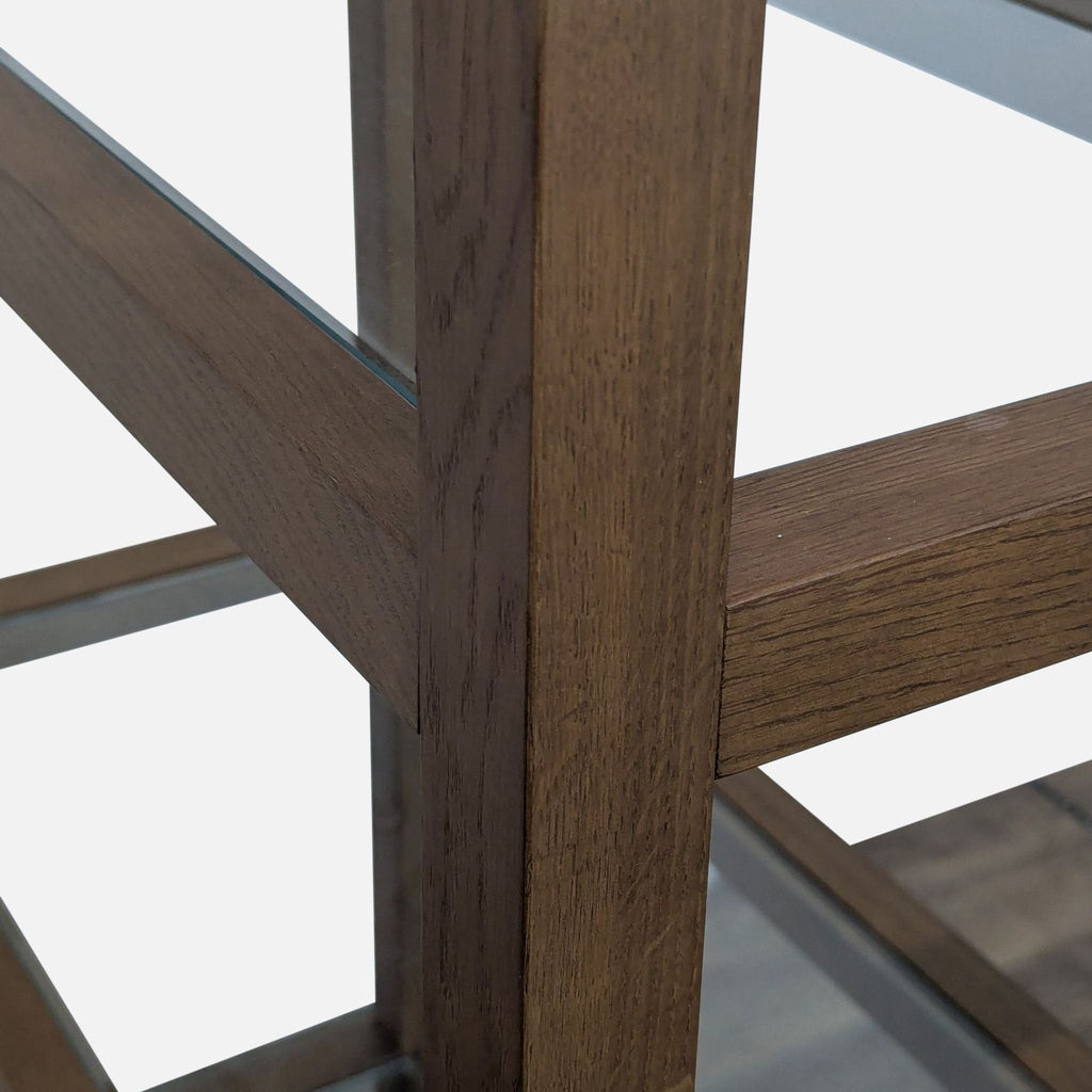 Close-up of the wood frame and glass shelves of Reperch bookshelf.  