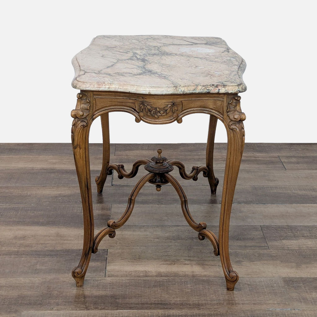 Elegant console table by Reperch with decorative woodwork and a marble surface.