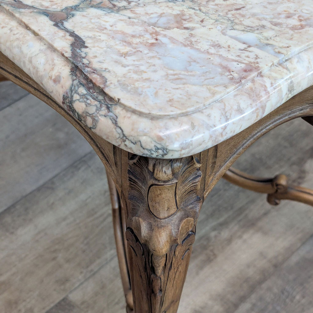 Close-up of the Reperch table's marble top and detailed woodworking.