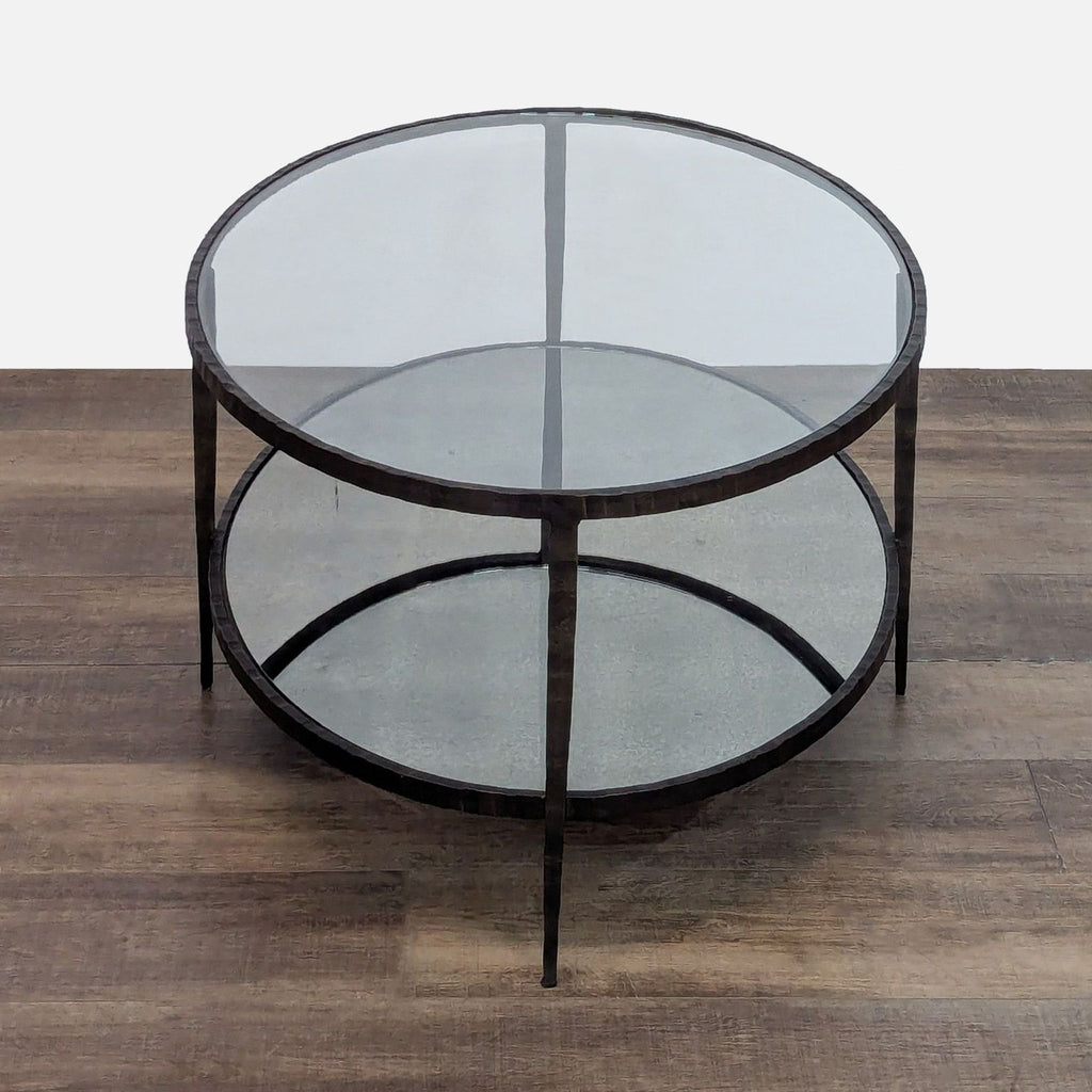 Round glass coffee table with a dual-layer metal frame.