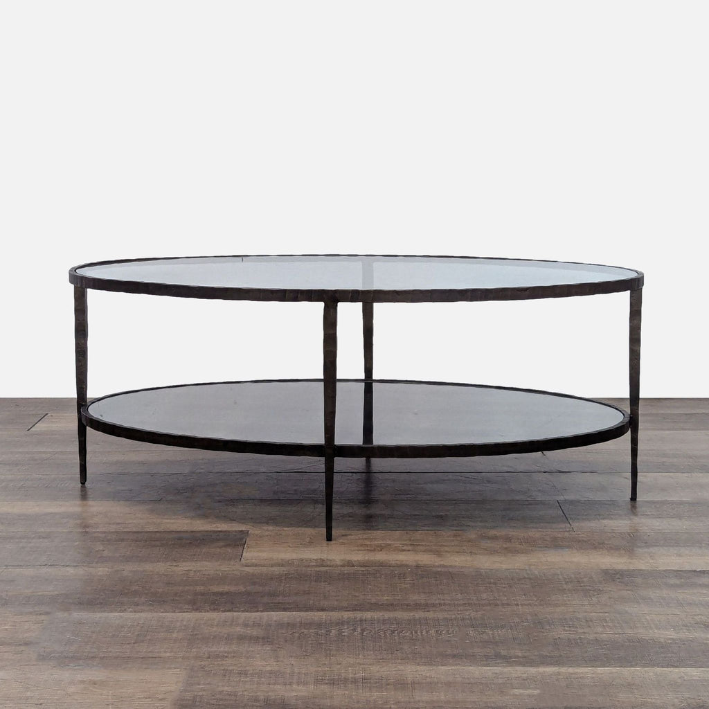 Reperch coffee table with hammered metal frame and glass top.