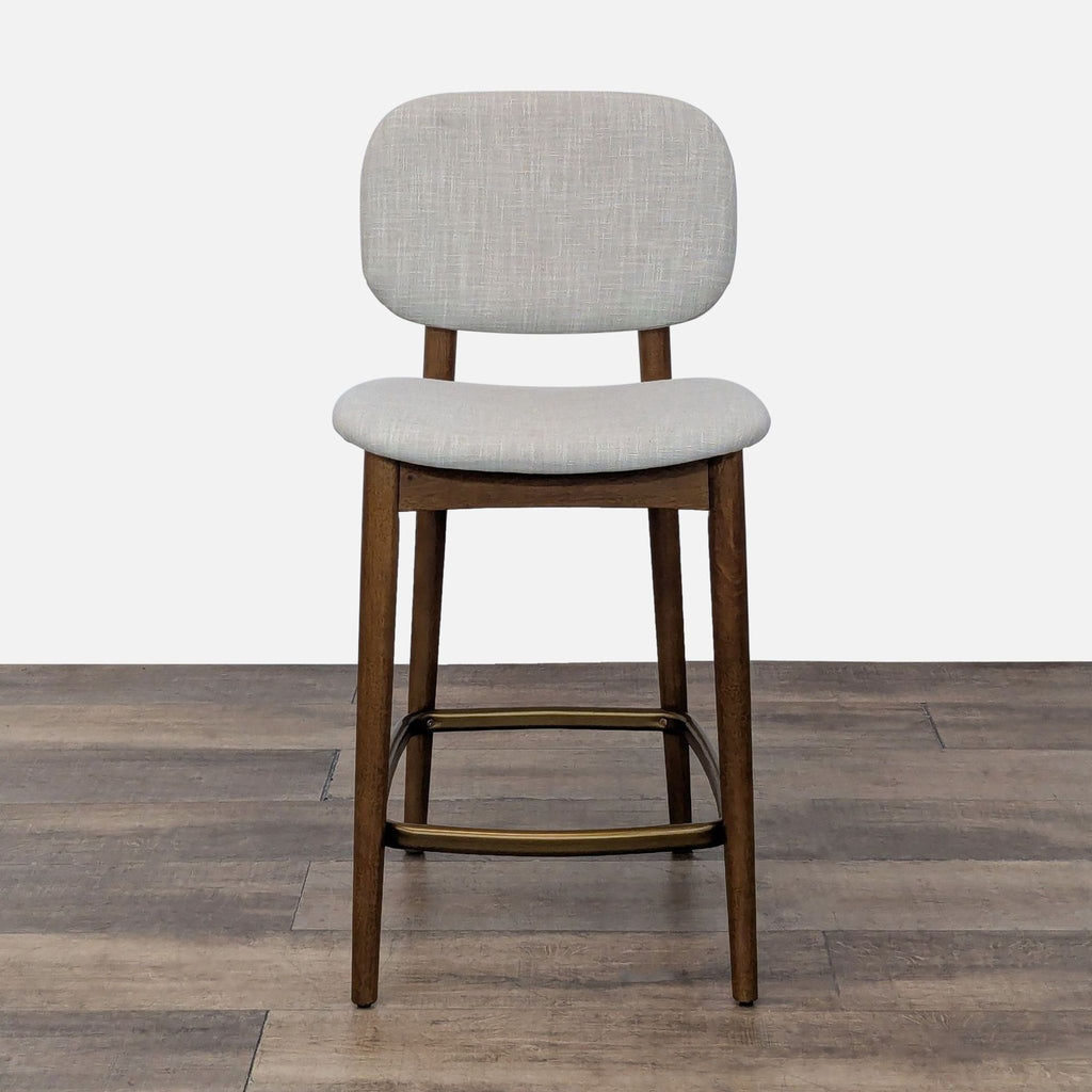 Front view of a stool with fabric upholstery, bent wood seat and back, and rubber wood legs.