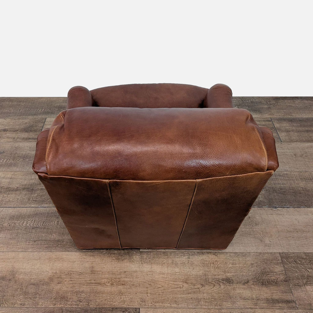 3. Rear angle of a Whittemore-Sherrill lounge chair shows smooth brown leather upholstery and plush headrest.