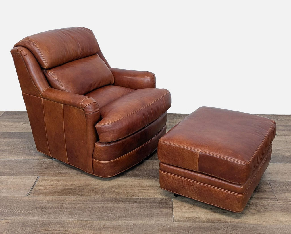 2. Side view of a cushioned Whittemore-Sherrill leather lounge chair and a matching ottoman on wood flooring.