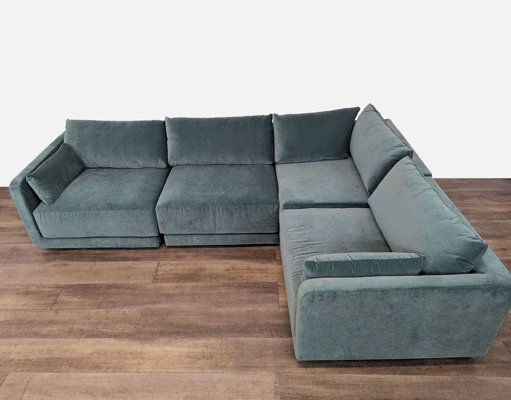 Luxurious velvet sectional with deep, plush cushions and stylish canted design by Benchmade Modern.