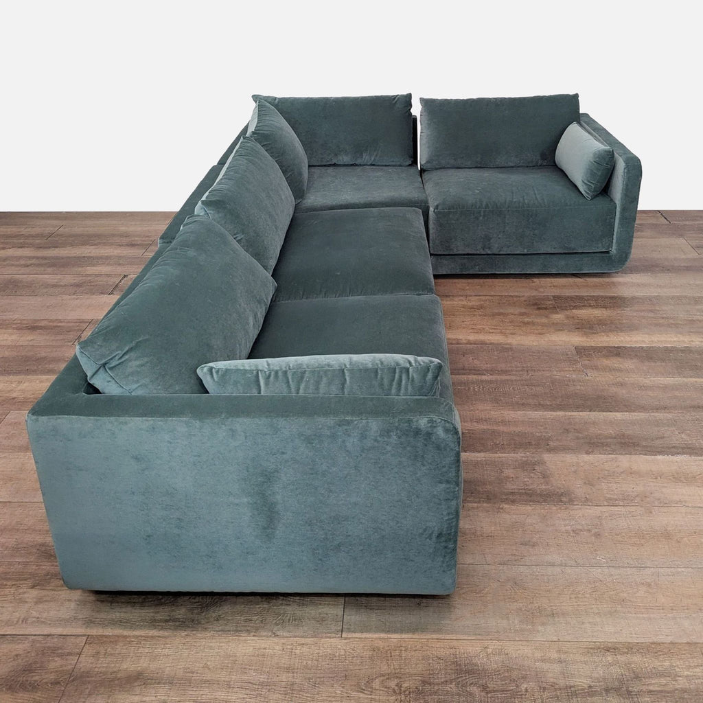 Elegant L-shaped velvet sectional with a modern design and inviting cushioned seats by Benchmade Modern.