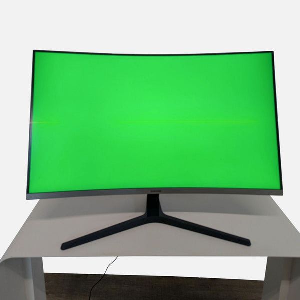 1. Front view of a Samsung 32-inch curved monitor with a vibrant green display on a white desk.