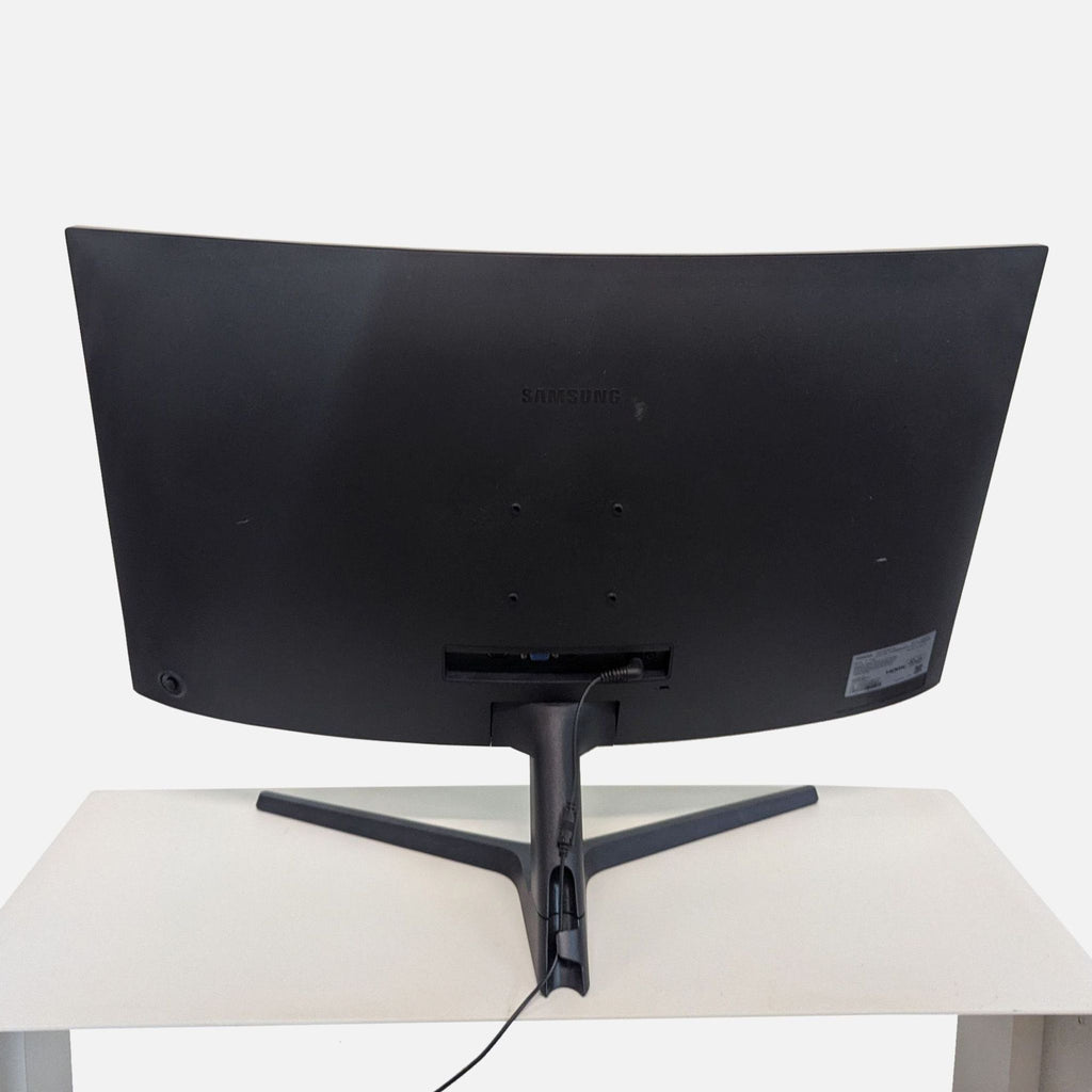 3. Rear view of a Samsung 32-inch curved monitor, displaying its sleek, black modern back and connected cable.