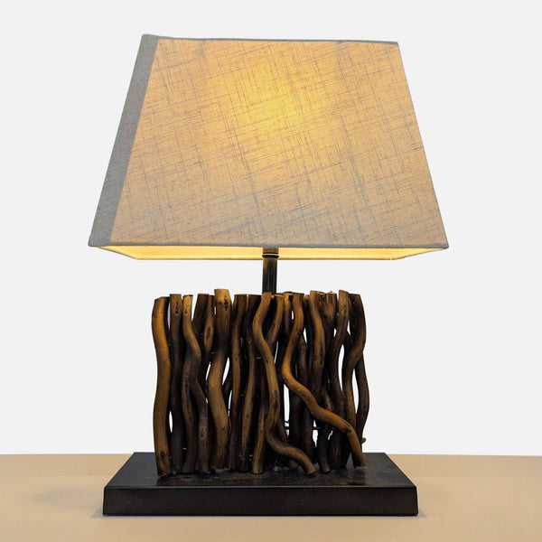 Lamp with fabric shade and a body crafted from twisted twigs on a metal base, by Reperch.