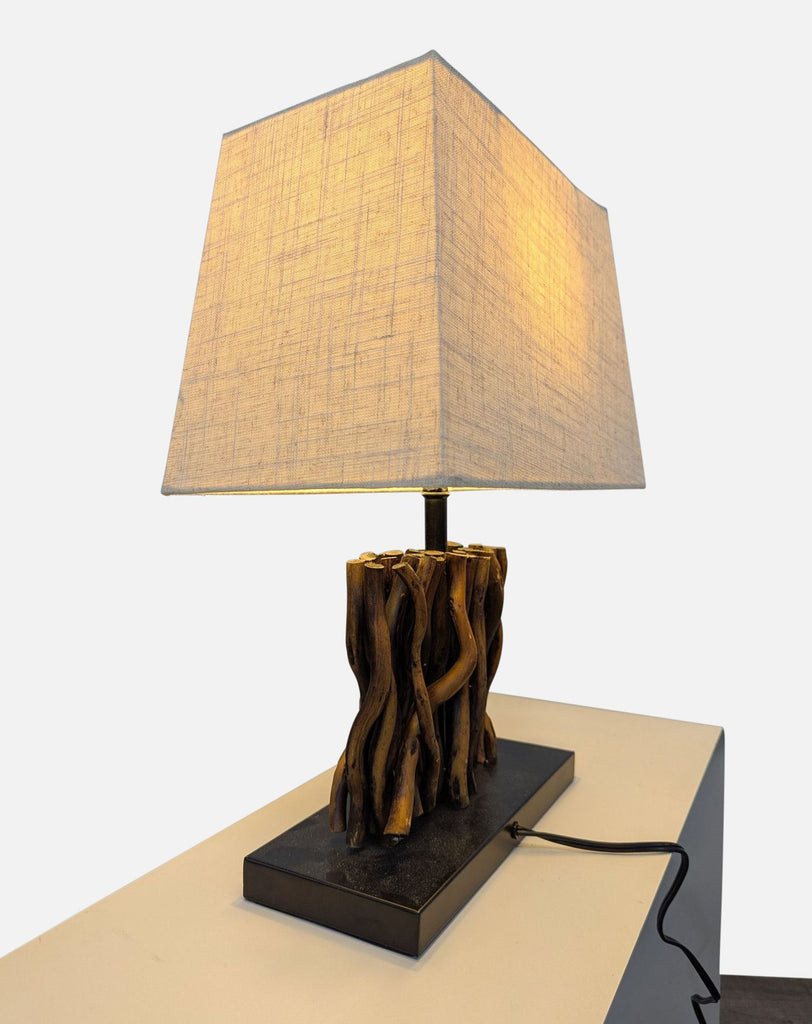 Side view of Reperch lamp featuring a fabric shade and twig body on rectangular metal base.