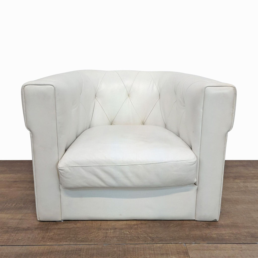 1. White West Elm lounge chair with curved back, squared arms, and diamond-tufted leather upholstery, front view.