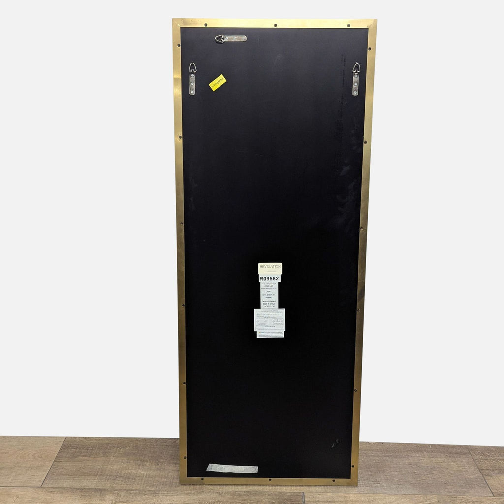 Back of mirror with brass frame and mounting instructions.