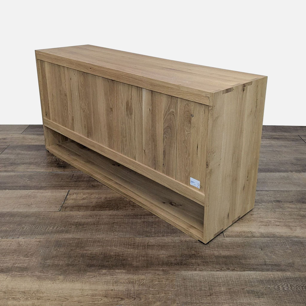 Back view of Reperch wooden sideboard on a wooden floor.