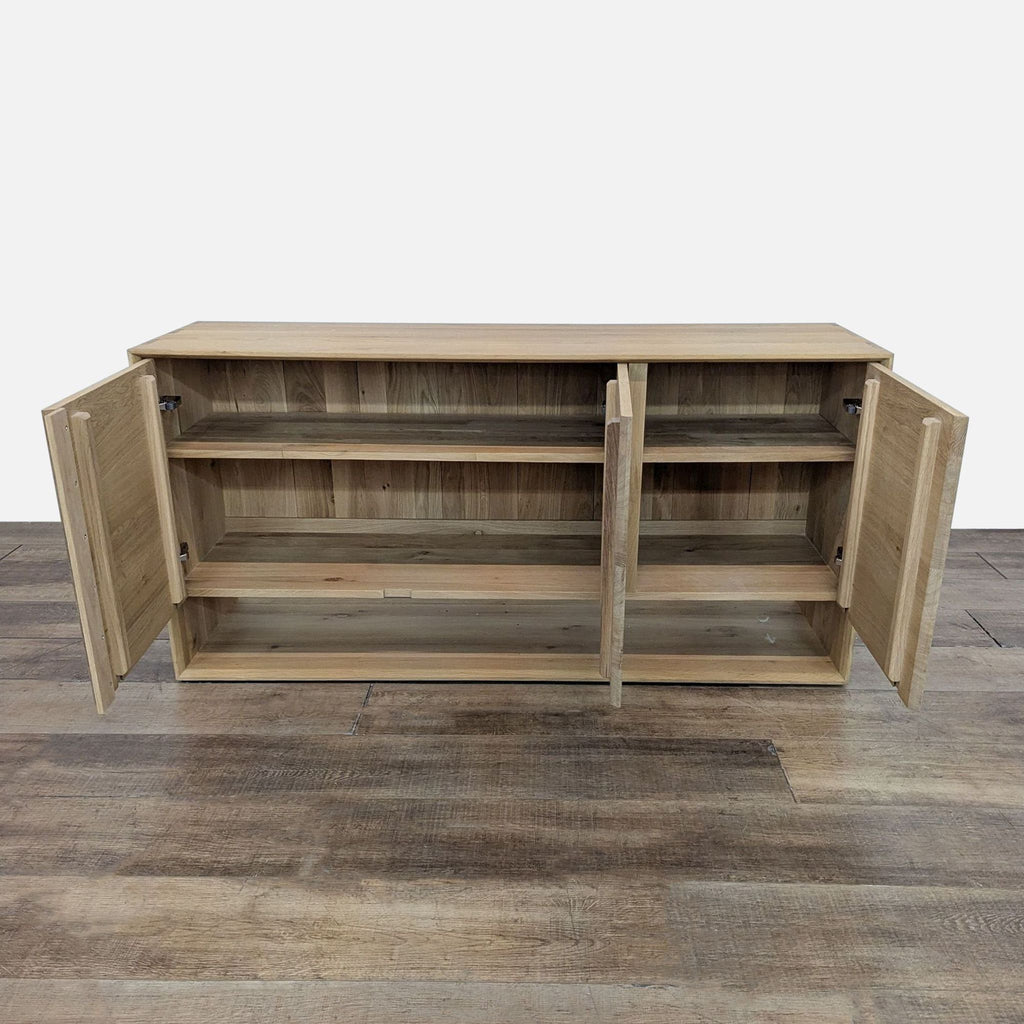 Reperch sideboard with open doors showing interior shelves on a wooden floor.