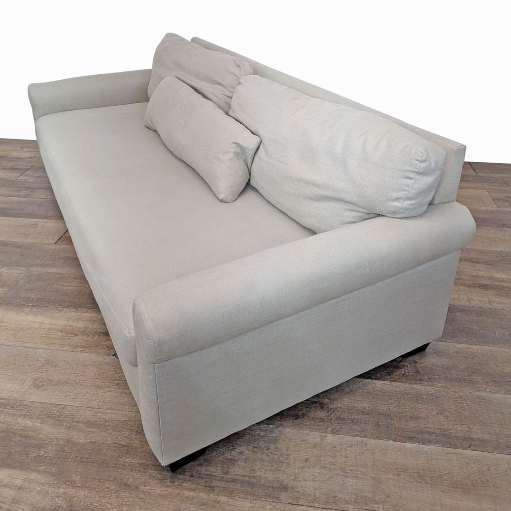 3. Angled view of Pottery Barn's York 3-seat sofa, featuring two back cushions and solid rubberwood legs.