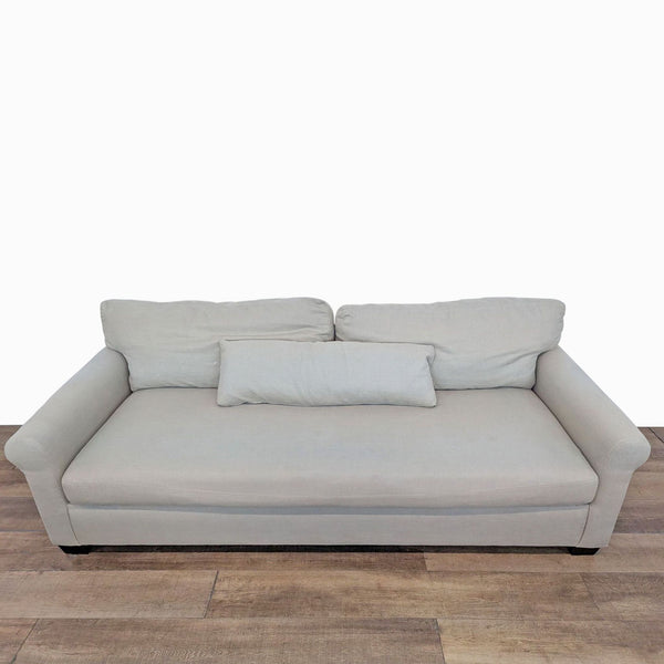 1. Front view of a Pottery Barn York 3-seat sofa with bench cushion and removable back cushions on wood legs.  