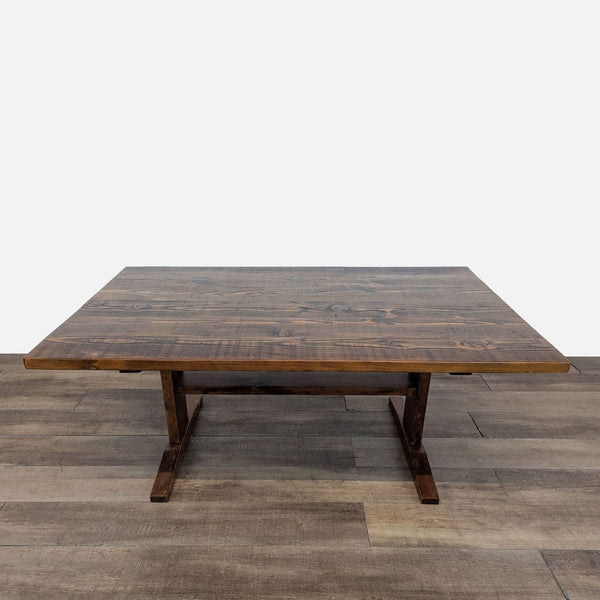 Reperch dining table, dark wood finish, on wooden floor.