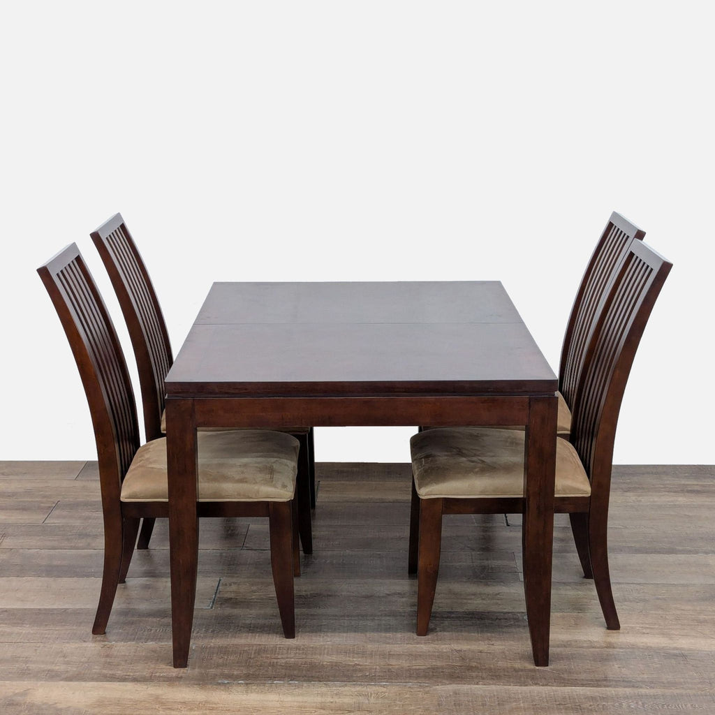 2. Side view of Legacy Classic expandable dining table with four matching slatted back chairs and cushioned seats.  