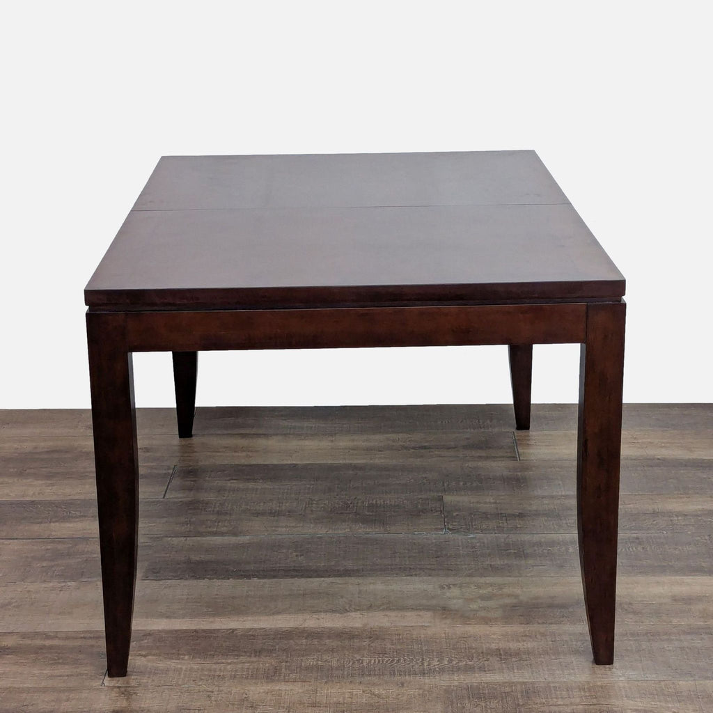 3. Dark wood expandable dining table with clean lines by Legacy Classic Furniture, shown without chairs.