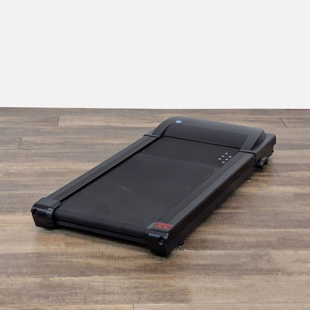 3. Angled view of Lifespan compact treadmill, a slim gym equipment designed to fit under most desks.