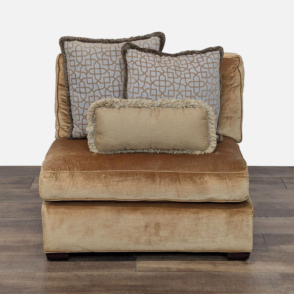 1. Front view of a Reperch armless lounge chair in gold upholstery with three decorative accent pillows.