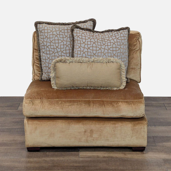1. Front view of a Reperch armless lounge chair in gold upholstery with three decorative accent pillows.