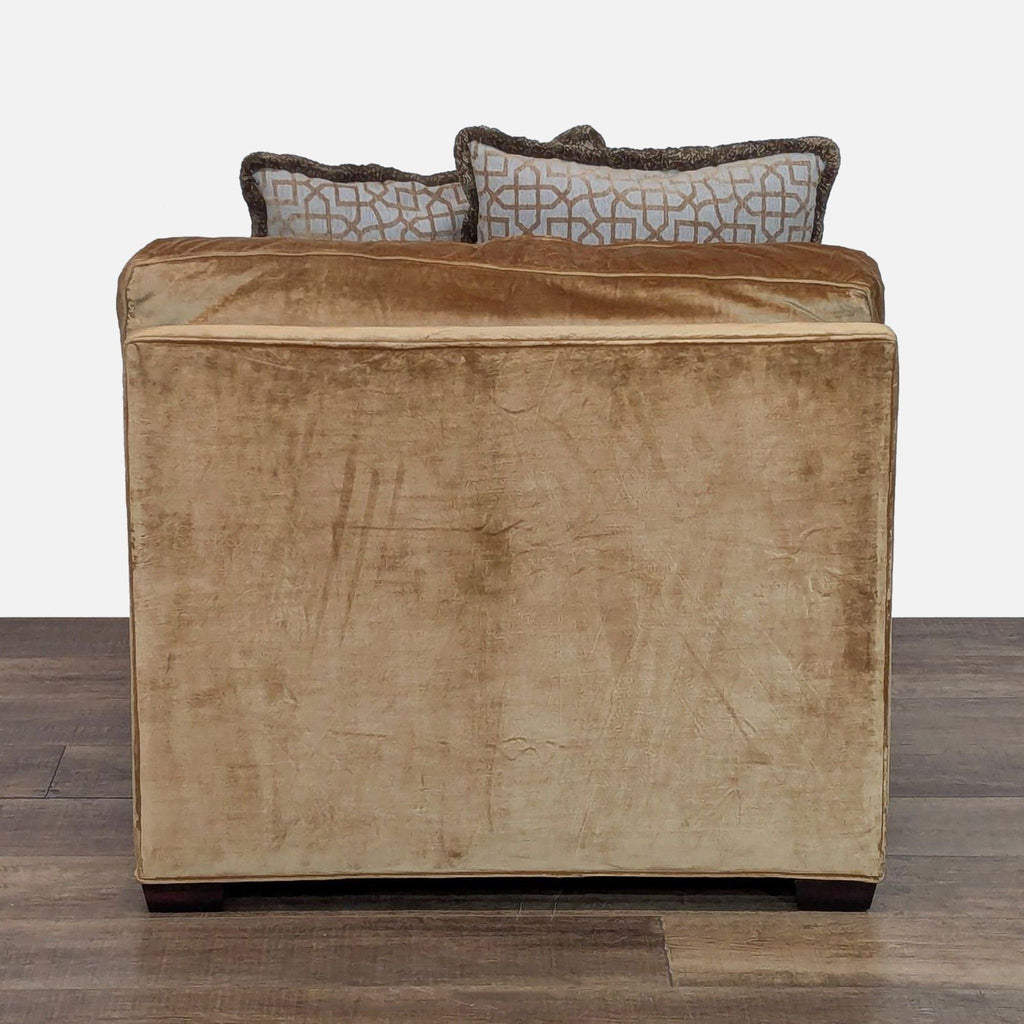 3. Rear view of a gold upholstered Reperch lounge chair, partially showing its accent pillows above the backrest.