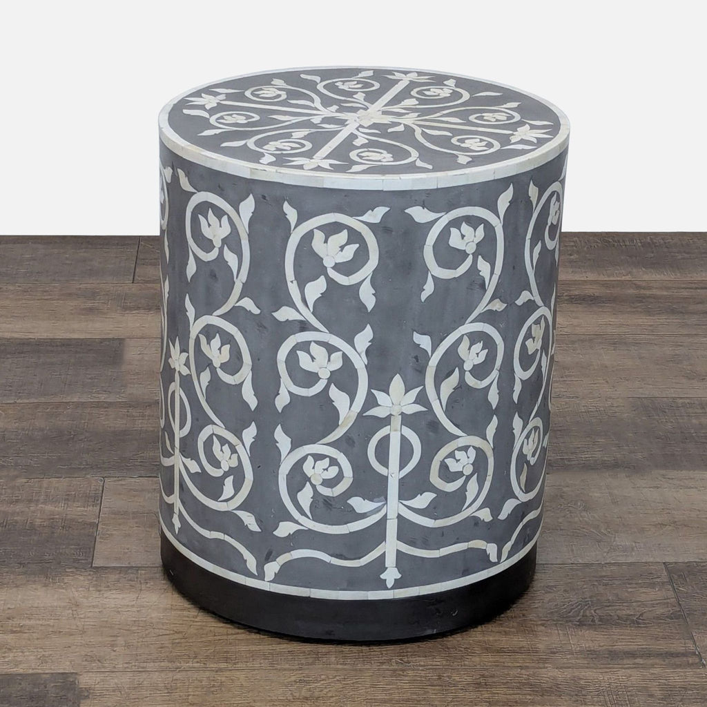 1. Cylindrical Reperch side table with a gray base and intricate white floral bone inlay pattern.