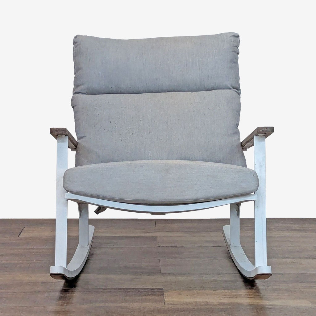 1. Modern white aluminum rocking chair with thick gray seat pad and teak armrests, front view, by Article.  