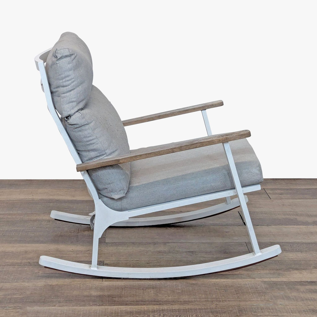 2. Side view of an Article brand chair featuring weather-resistant cushion, white frame, and sleek teak armrests.  