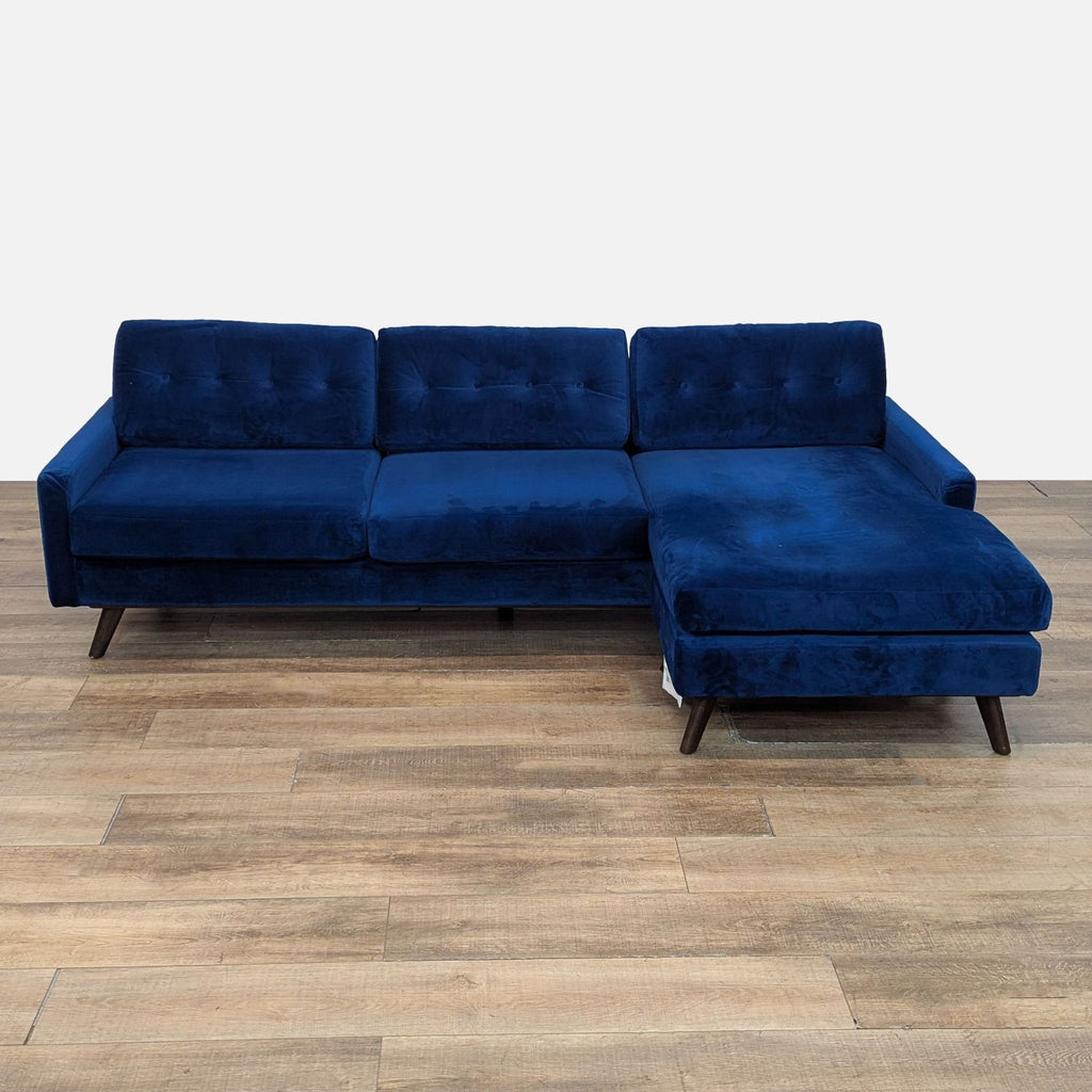 1. Joybird sectional with Royal Cobalt velvet, tufted back cushions, and wood legs, viewed from the front.