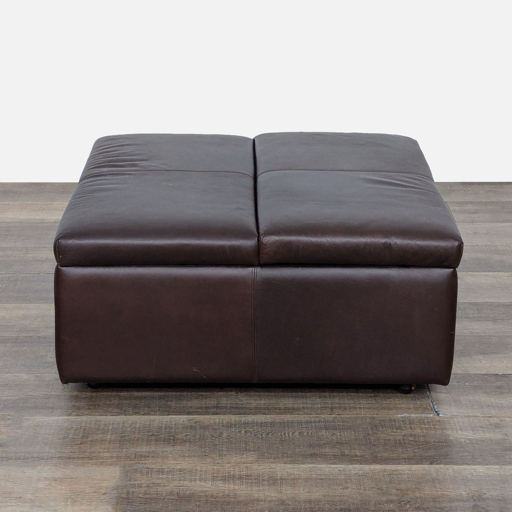 1. Dark brown leather ottoman from McCreary Modern with a sleek, rectangular design shown on wood flooring.