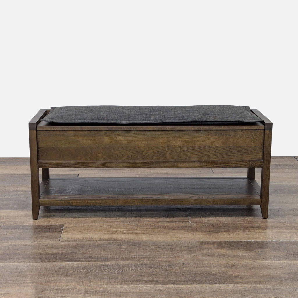 1. Wooden bench by Room & Board with a cushioned top and lower shelf, ideal for storage and seating.