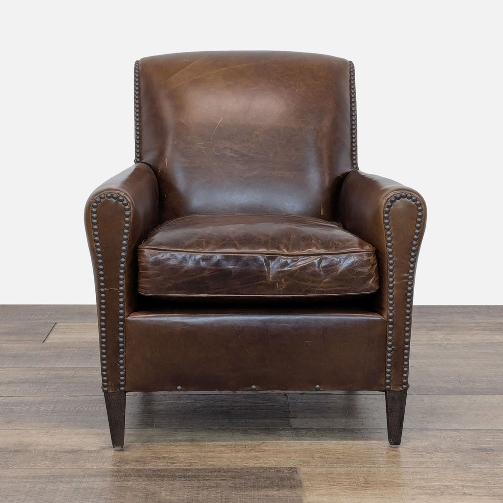 1. Restoration Hardware lounge chair with rolled arms, distressed brown leather, and nailhead trim, front view.  