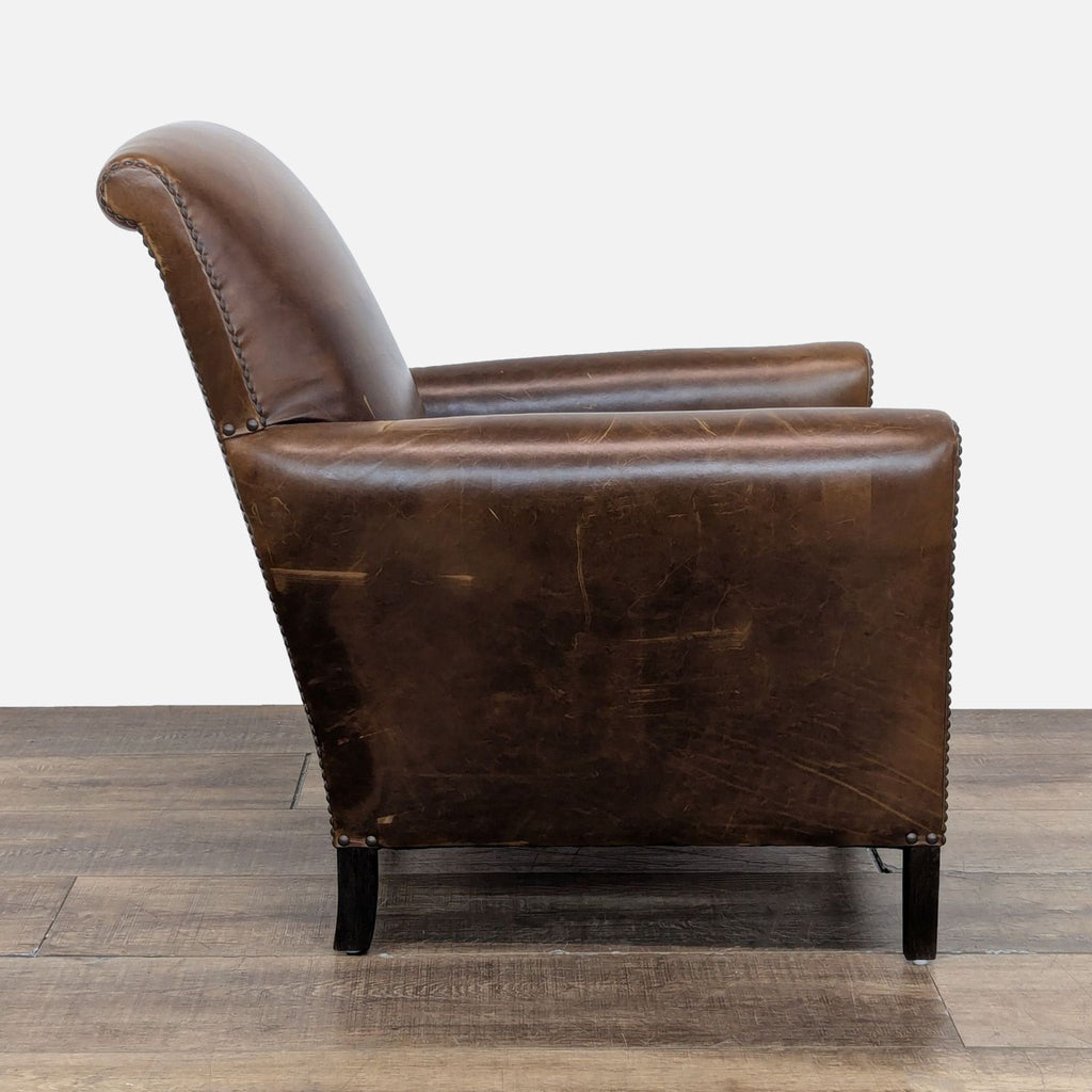 2. Side profile of a Restoration Hardware lounge chair showing rolled arms and distressed leather upholstery.  