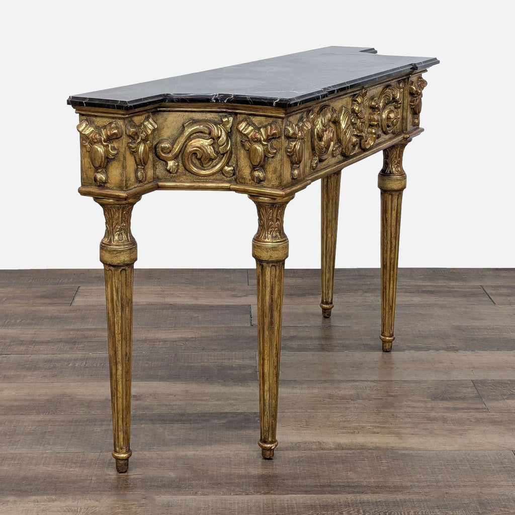 2. Three-sided Charles Pollock/William Switzer console with intricate gilded carvings and marble top, angled view.