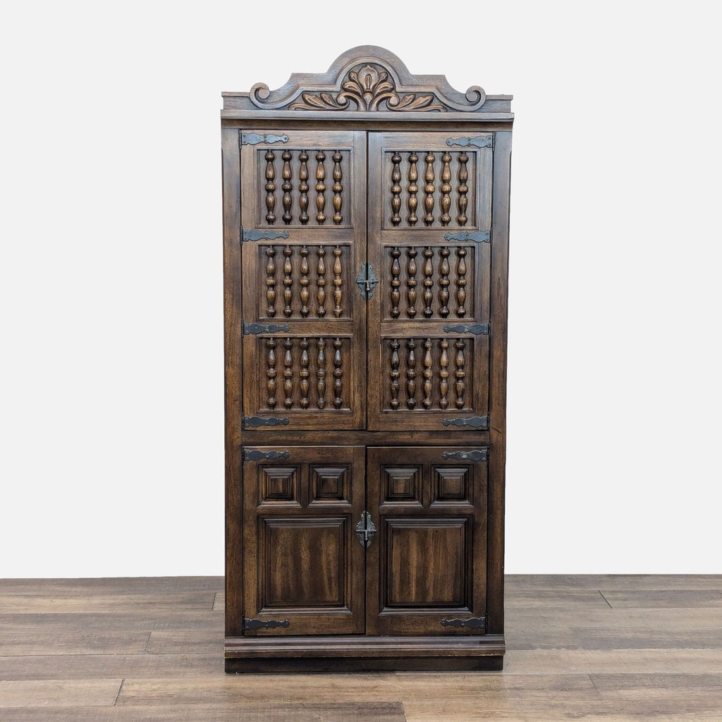1. Dark wood Reperch cabinet with carved top, metal accents, spindle upper doors, and paneled lower doors.