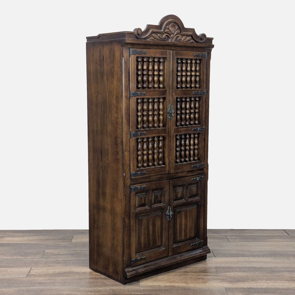 3. Angled view of Reperch cabinet showing decorative carving, metal embellishments, raised panels, and spindle doors.