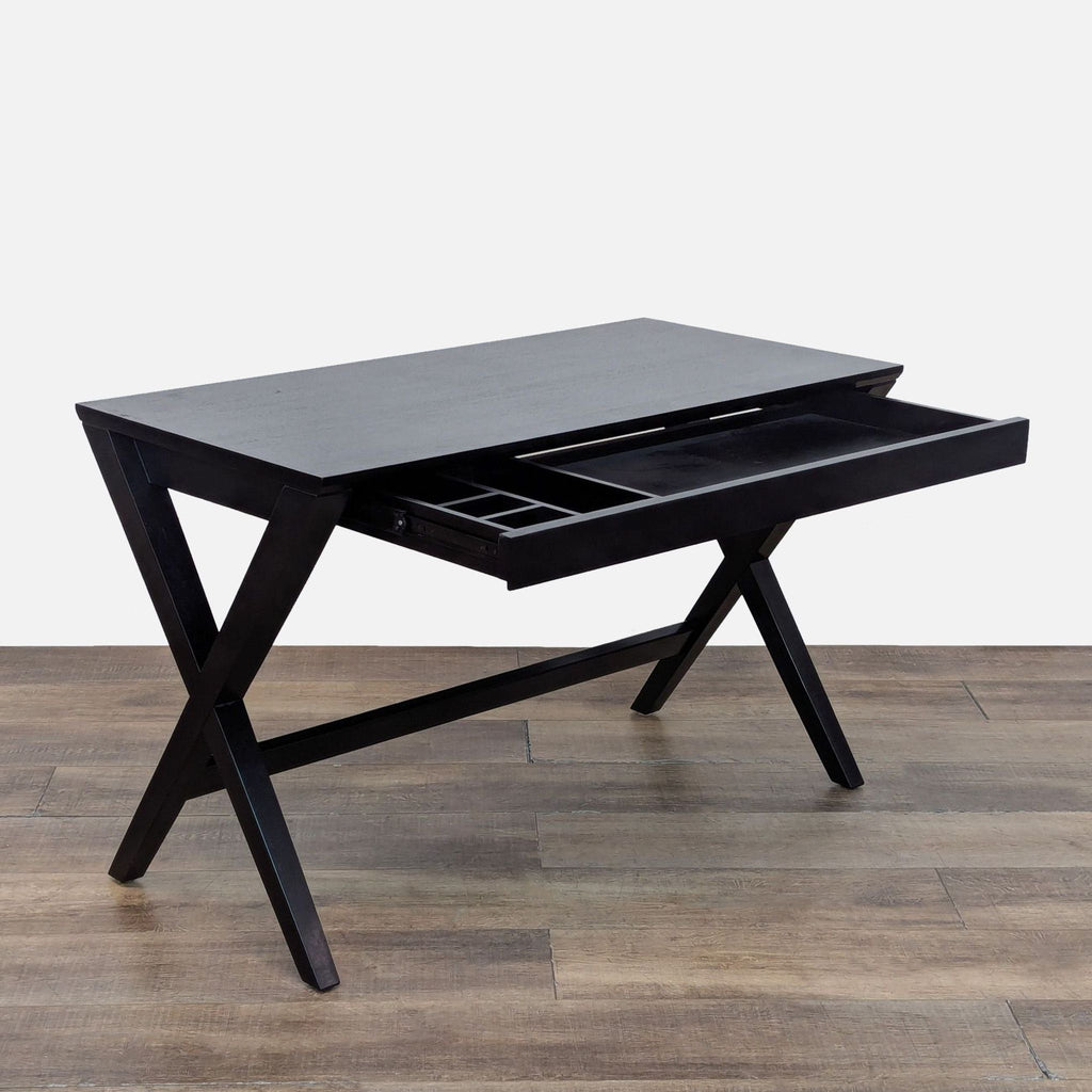 2. Black-stained Crate and Barrel desk with open wide drawer for storage, showing interior compartments.