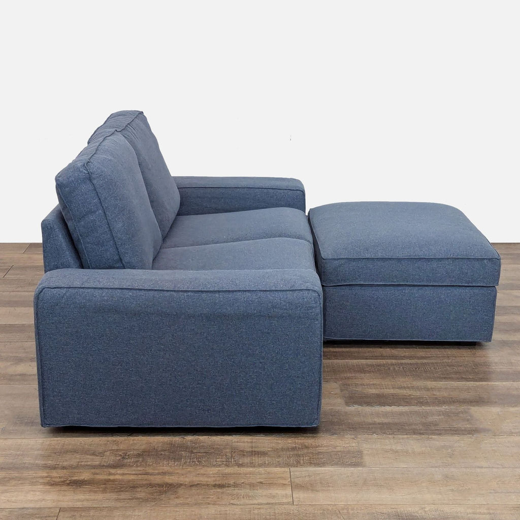 2. Side profile of a blue Ikea Kivik sectional loveseat, featuring wide armrests and plush seating.  