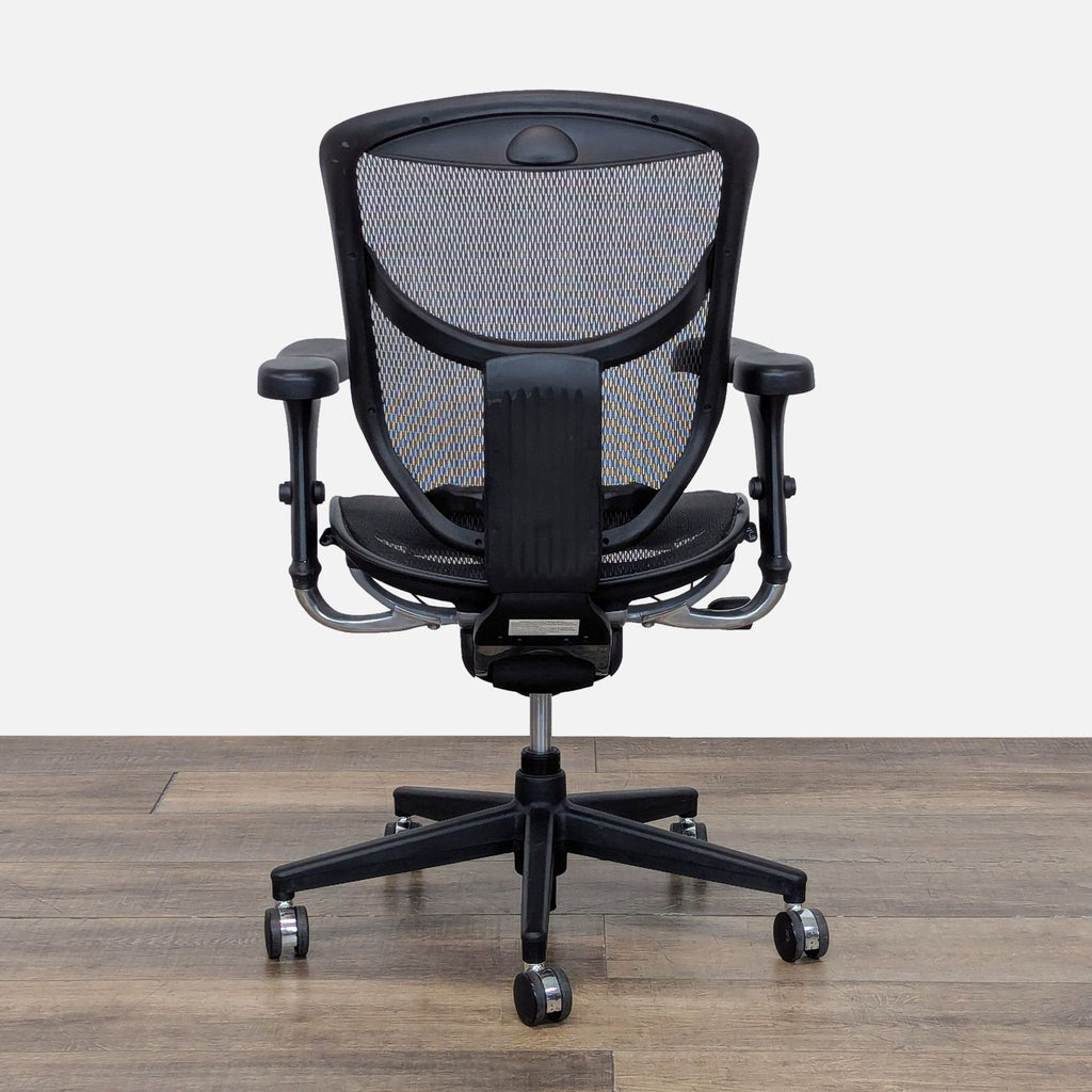 3. Rear view of a Realspace chair showcasing the mesh back, customizable lumbar, and adjustable arm height on casters.