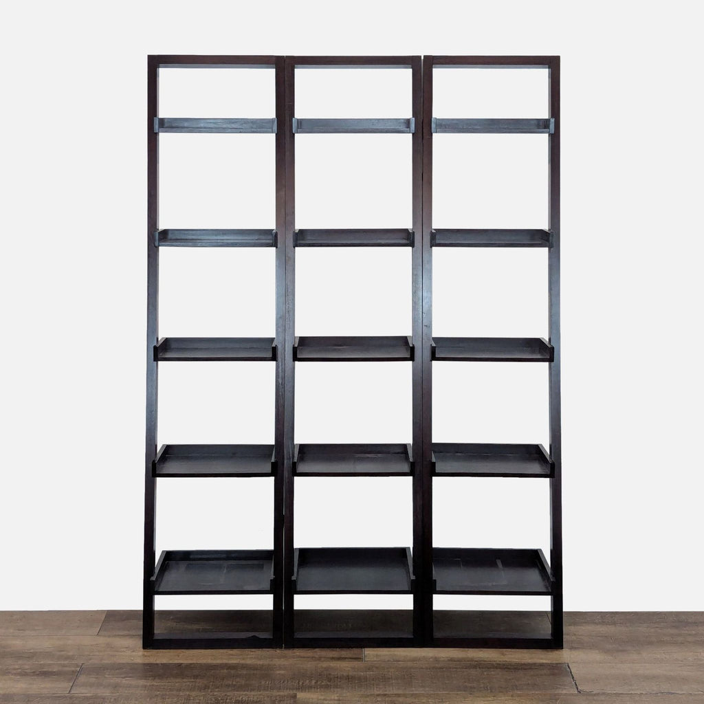 1. Set of three modular Crate & Barrel hardwood bookcases with five black deep shelves and thick fronts.