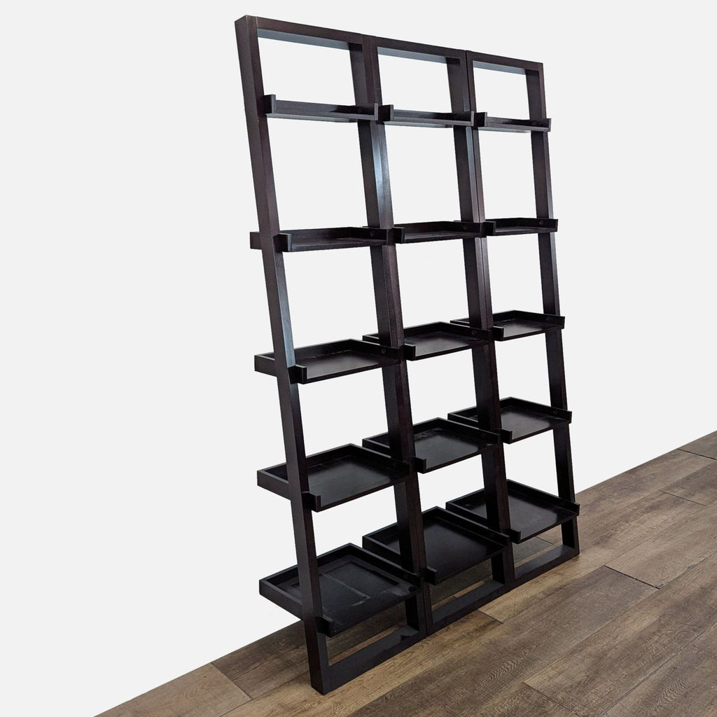 2. Angled view of Crate & Barrel modular black hardwood bookcases, each with five spacious, sturdy shelves.
