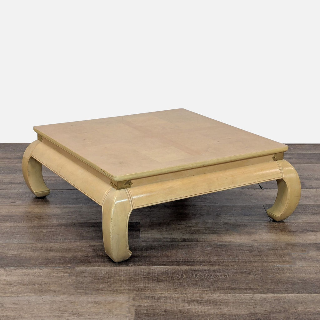 3. Cream lacquered Bernhardt coffee table, square form, burl inlay top, brass accents, and curved legs, angled view.