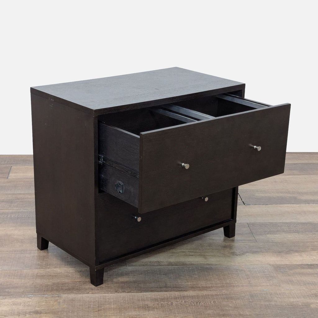 2. Angled view showing one open drawer on a dark walnut two-drawer cabinet with metal pulls by West Elm.