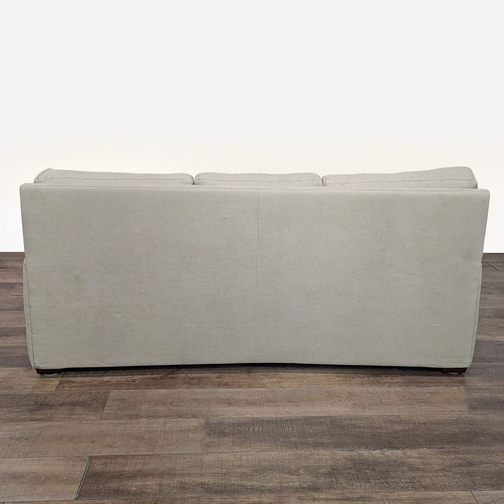 3. Rear view of the beige American Upholstery sleeper sofa highlighting the simple back and Bella Suede upholstery.
